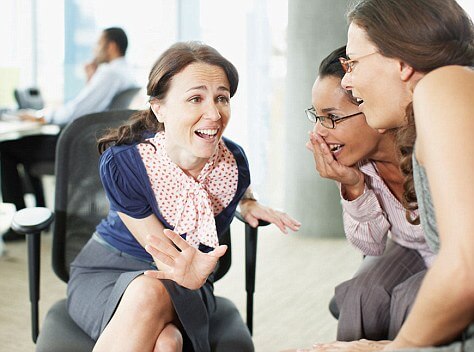 Businesswomen gossiping in office